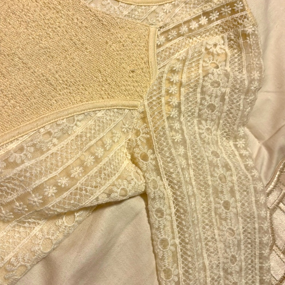 White and cream sweater, perfect for any season. Detailed and stylish.